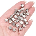 Macro shot of silver star-shaped CCB beads held in hand for DIY jewelry making - Star 10mm (20pcs/pack)