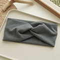 Detailed view of gray fabric knot headband with soft texture on a natural tray - Gray