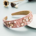 Close-up of pink crystal headband with faux pearls and gold bead chain edge detail - Pink