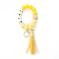 Detail of MAMA silicone bead keychain with yellow tassel and natural wooden accent - Yellow