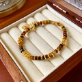 Detail of tiger eye stone beads and irregular gold metal links on a vintage bracelet - Bracelet-Brown