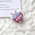 Macro shot of blue and purple hand-painted goldfish ceramic bead for DIY jewelry making - Price per Piece / White with Purple and Blue Patterns