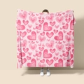 Detail of pink flannel blanket featuring heart patterns held by model on plain background - Style 56 (Pink Hearts)