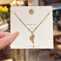 Collana in acciaio al titanio dorato con ciondolo a forma di zucca e carattere Fu - Stile Zucca Fu (X550) / Oro