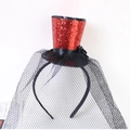 Close-up of a red sequin mini top hat headband with black floral accents and mesh veil - Red with Veil