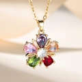 Golden five-petal flower necklace with colorful pear-shaped zirconia stones on silk background - Colorful Flower Necklace