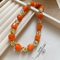 Detail of beaded bracelet with orange marble acrylic beads and irregular gold metal beads - Orange Necklace