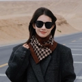 Outdoor winter scarf featuring a classic houndstooth pattern in black, beige, and brown tones - Houndstooth Caramel