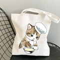 White canvas tote bag featuring cute cartoon cat print with comfortable shoulder straps - Chef Cat Licking Paw
