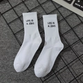 White crew socks featuring Life Is A Joke slogan and ribbed cuffs for sports - Life Is A Joke