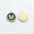 Detailed macro view of enamel butterfly pendant showing embossed front and textured back - Green