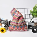Detail of colorful geometric pattern and linen texture on Japanese wrist knot bag - Red Ethnic Style