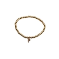 Detailed shot of a gold beaded bracelet with a colorful zircon letter P pendant - Letter P