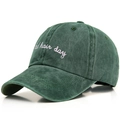 Close-up of vintage dark green washed cotton baseball cap with white embroidery - One Size / Dark Green