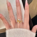 Vintage style gold and silver ring with pink pavé crystals worn on a model's finger - Gold and Silver Two-Tone Star Small Particle Layered Ring (J6625)