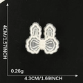 White embroidered lace bow patch for DIY hair clips, size 4cm x 4.3cm on black background - White Rabbit Ear Shape Bow