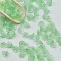 Detail of light green frosted lily of the valley glass beads on a white background - Lily of the Valley 3# Apple Green 7x12mm