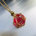 Unique gold mesh cage pendant necklace with a translucent red polyhedral dice - Gold Cage with Rose Pink Dice