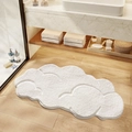Absorbent white cloud-shaped bathroom mat with soft plush texture on wooden floor - White Cloud