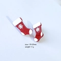 Macro detail of red glitter Christmas sock earrings with snowflake patterns and size info - Christmas Sock