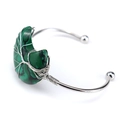 Detail of silver wire-wrapped tree of life design on crescent moon green stone bangle - Synthetic Malachite