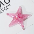 Roze zeester van hars met kristallen steentjes op een minimalistische kaart - Rozenkwarts Schittering
