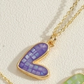 Golden heart necklace featuring a purple mosaic shell pendant and fine cross chain - Purple