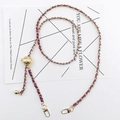 Detail of a purple leather-woven gold metal chain strap with a decorative gold ball charm - Purple
