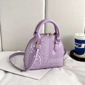 Detail of lavender shell bag with paisley patterns, golden hardware and shoulder strap - Purple