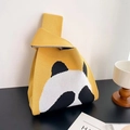 Handmade knitted yellow handbag featuring a cute panda pattern and woven wrist strap - Yellow Shy Panda