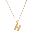 Close-up of golden stainless steel necklace with textured letter H alphabet pendant - Letter H