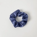 Detailed view of the dark blue satin scrunchie with smooth silk-like texture and elasticity - Without Card / Sapphire Blue