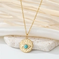 Detailed close-up of golden necklace pendant with turquoise evil eye and wavy texture - Turquoise Round Eye