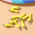 Macro shot of yellow chili pepper alloy charms with silver loops for DIY jewelry making - Yellow