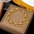 Elegant gold oval twisted chain bracelet on a brown jewelry box background - Twist Rope Chain Gold