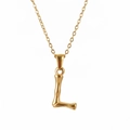 Golden bamboo texture pendant necklace featuring the letter L in a polished metal finish - Letter L