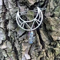 Silver hollow moon hair clip with rainbow crystal pendant on natural bark background - Multicolor Crystal