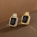 Macro view of gold-plated square black zircon earrings with sparkling halo detail - Black Zirconia