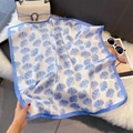 Detailed view of silk-like neckerchief featuring blue shell patterns on plush background - 70*70cm / Blue Shell