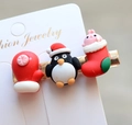 Detail view of Christmas hair clips featuring resin penguin and holiday glove charms - Style 9 Christmas Hair Clip