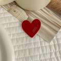 Detailed close-up of a red heart acetate hair clip with white FRANCE Handmade text - Red