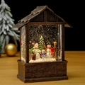 Macro shot of bronze Christmas snow globe lantern with snowman family and silver glitter - Three Snowmen