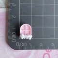 Close-up of a mini pink resin window charm on a centimeter scale for DIY crafts - Cloud Window