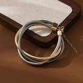 Detailed view of layered gold and silver spring collar bracelet with extension chain - Mixed Color Wound Bracelet