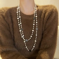 Elegant double-layered pearl long necklace featuring white and black camellia flower pendants - Black and White Camellia Long Pearl Necklace Gold