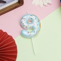 Blue donut-themed birthday candle shaped like number 9 with colorful sprinkles and white stick - Number 9 - Blue Donut