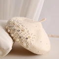 Detail of cream beige wool beret featuring elegant pearls and sparkling rhinestones - Beige