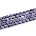 Macro shot of purple oval geode agate beads showing natural lava textures for DIY jewelry - Violet