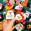 Handheld view of Christmas tumbler blind boxes with Santa and Snowman cartoons - Christmas Blind Box Roly-poly Toy / Price Per Box