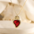 Retro gold heart necklace with red flame pendant and beaded edge detail on a gold chain - Red